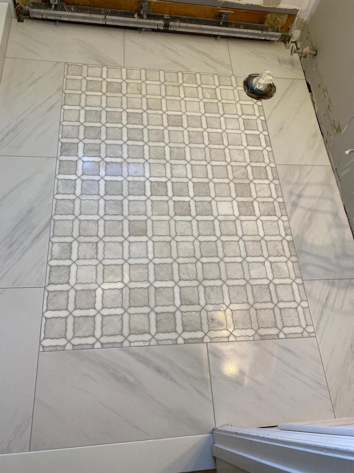 Custom bathroom floor mosaic installation by Souza Installation